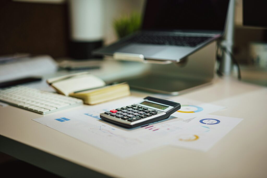 calculator and laptop on a desk