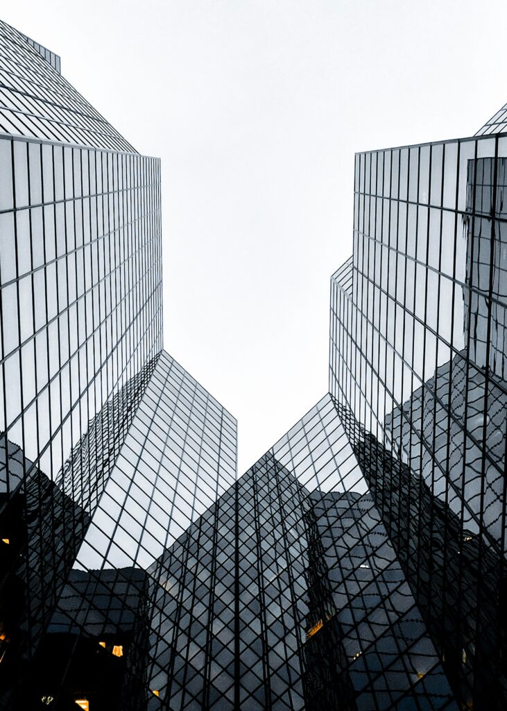 modern glass office building viewed from below