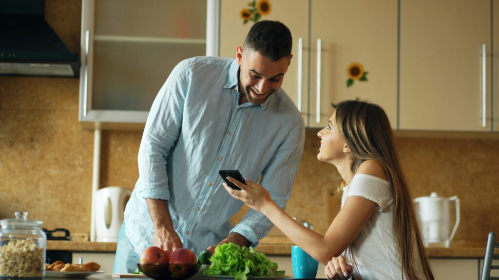couple smiling and talking at breakfast