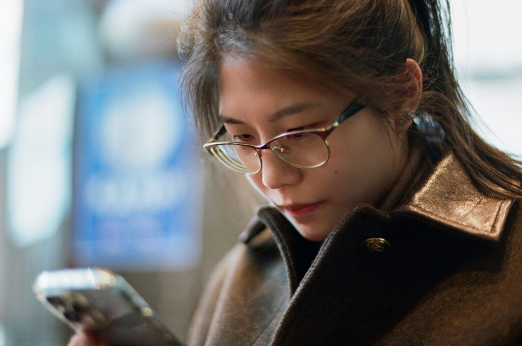 Person closely examining a photo on their phone screen