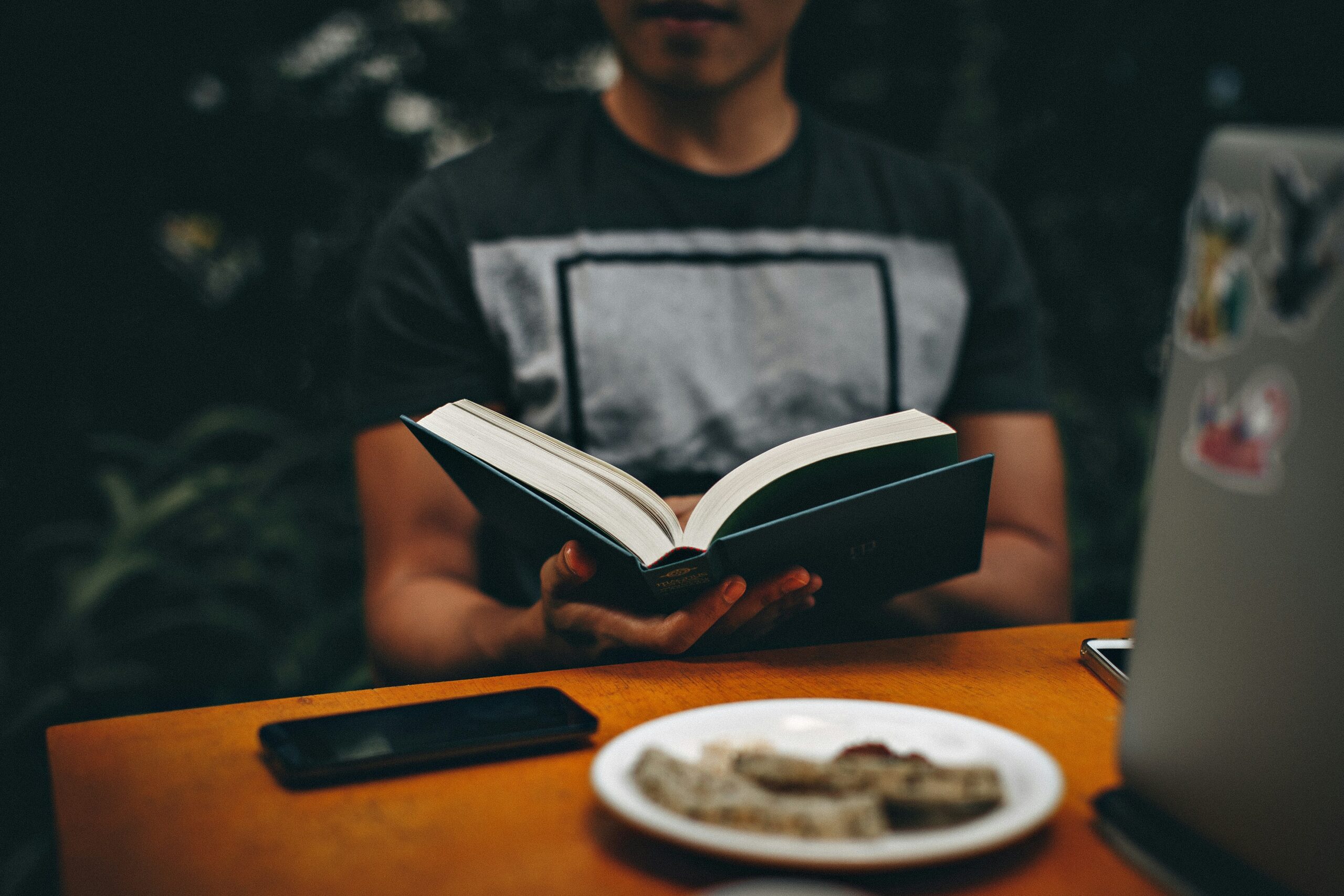 Person reading a book instead of using their phone