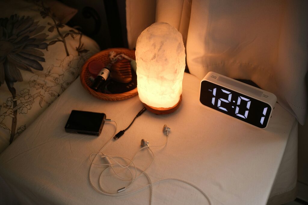 Phone charging on a nightstand in a dark bedroom