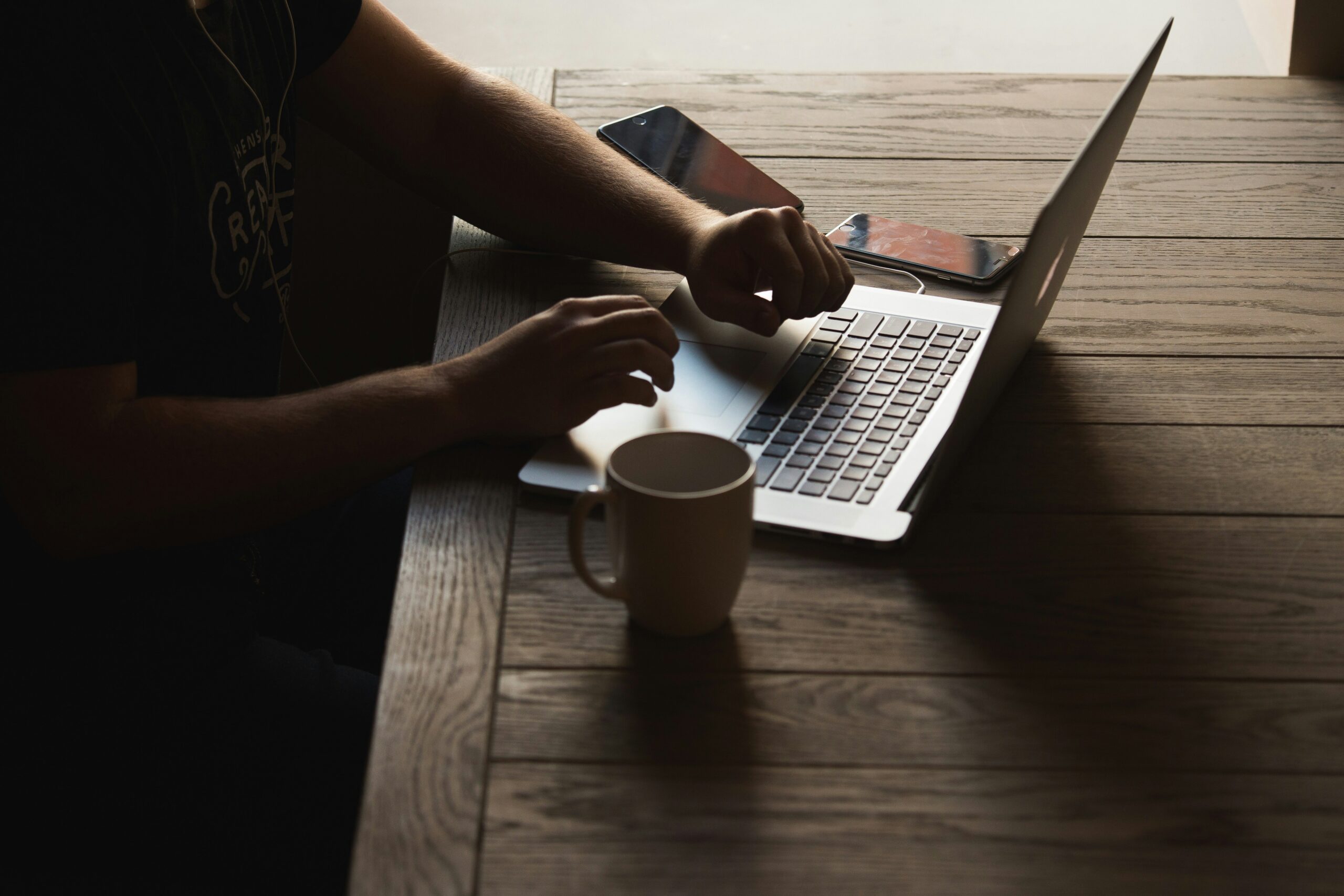 person using a laptop in a coffee shop